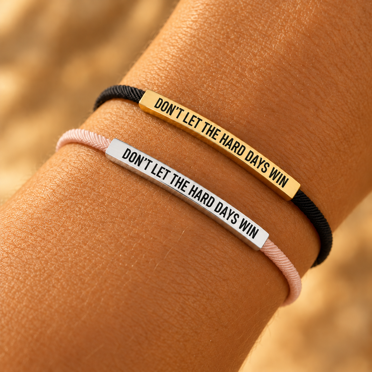 Don't Let The Hard Days Win armband, gold and silver on the wrist